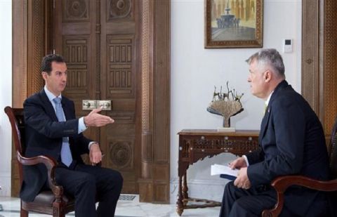 A handout picture released by Syria’s official SANA news agency on November 3, 2016 shows Syrian President Bashar al-Assad (L) giving an interview to the Serbian Politika newspaper in Damascus.